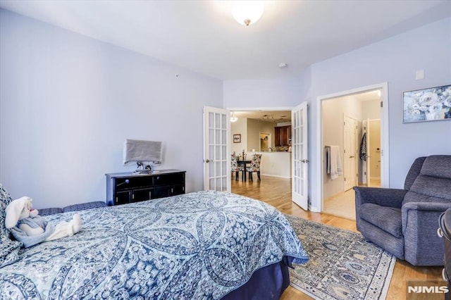 bedroom featuring hardwood / wood-style floors and french doors