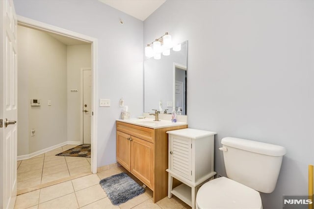 bathroom featuring toilet, tile patterned floors, and vanity