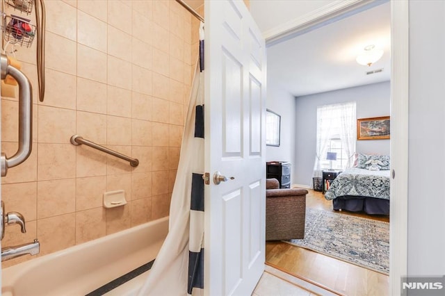 bathroom featuring shower / bath combination with curtain and hardwood / wood-style flooring