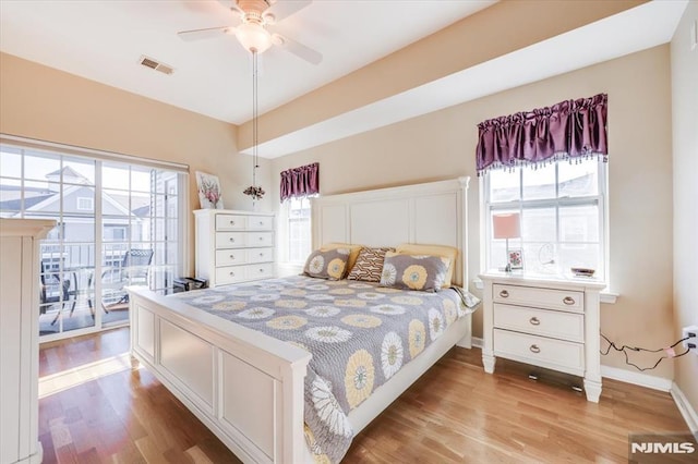 bedroom featuring access to outside, ceiling fan, and light wood-type flooring