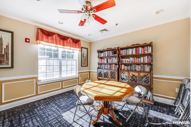 interior space featuring ceiling fan, ornamental molding, and carpet floors