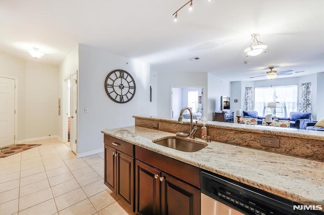 kitchen with ceiling fan, stainless steel dishwasher, sink, light stone countertops, and light tile patterned floors