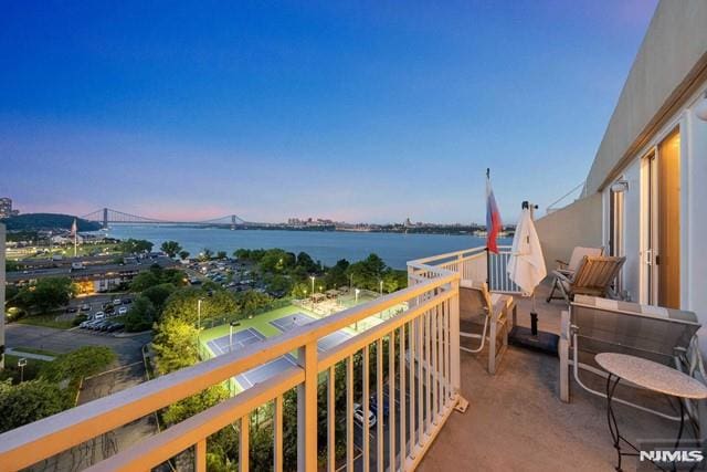 balcony at dusk with a water view