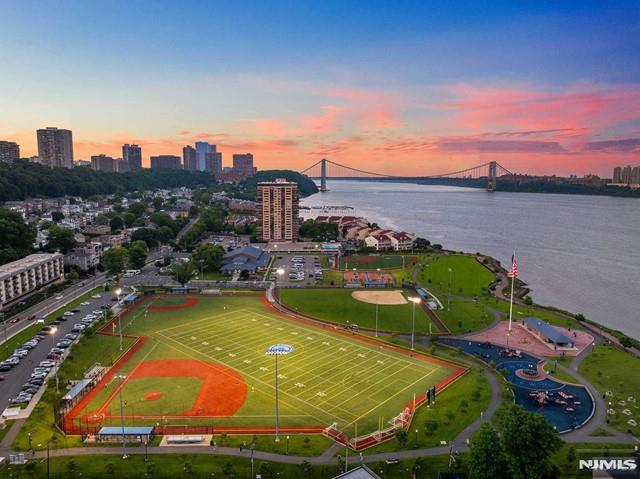 aerial view at dusk featuring a water view