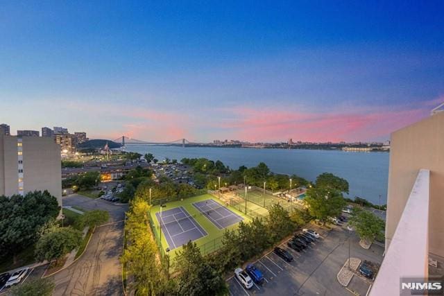 aerial view at dusk featuring a water view