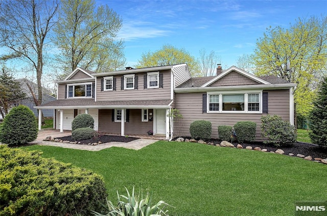 view of front of home featuring a garage and a front lawn