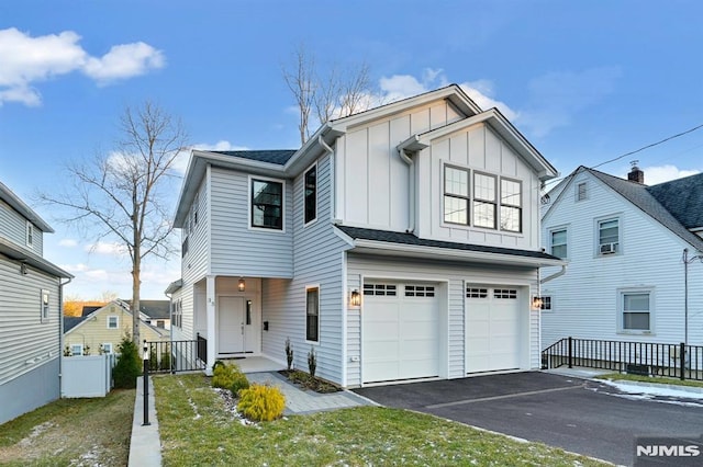 view of front facade with a garage and a front lawn