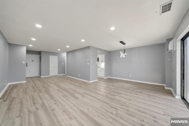 unfurnished living room with light hardwood / wood-style flooring