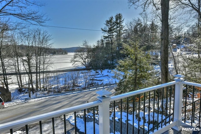 view of snow covered back of property