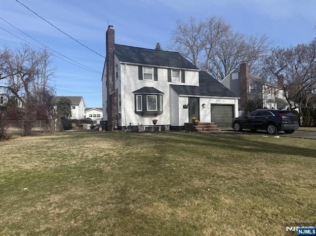 view of front of house with a garage and a front yard