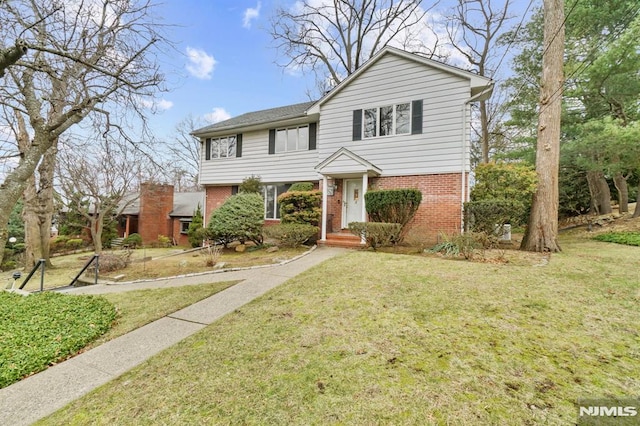 view of property featuring a front lawn