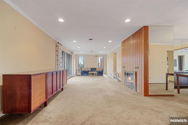 hallway with ornamental molding and carpet floors