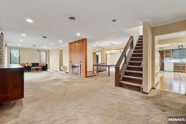 unfurnished living room with carpet, ornamental molding, and a notable chandelier