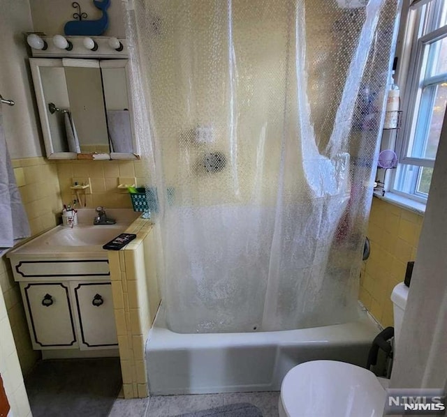 full bathroom featuring vanity, backsplash, tile patterned floors, toilet, and shower / tub combo with curtain