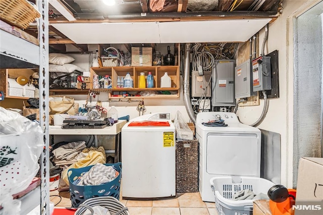 washroom with electric panel, light tile patterned flooring, and washer / clothes dryer