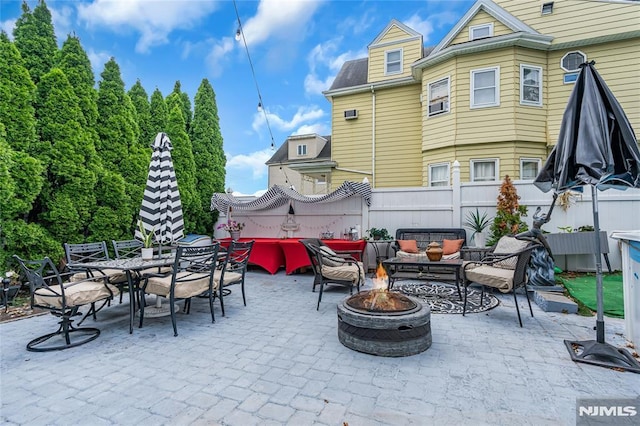 view of patio / terrace with an outdoor living space with a fire pit