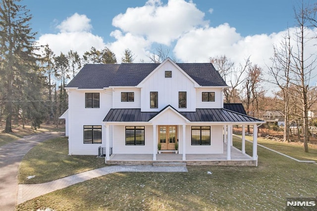 modern farmhouse style home with a front lawn