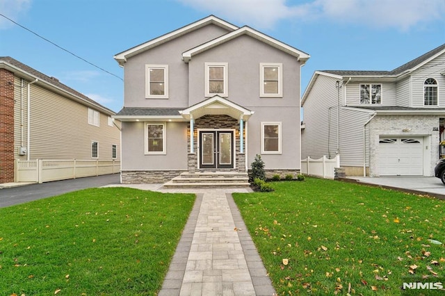 view of property with a front yard and a garage