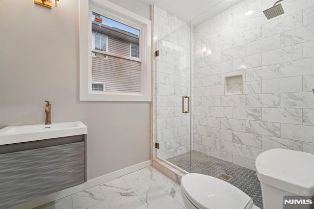 bathroom featuring walk in shower, vanity, and toilet