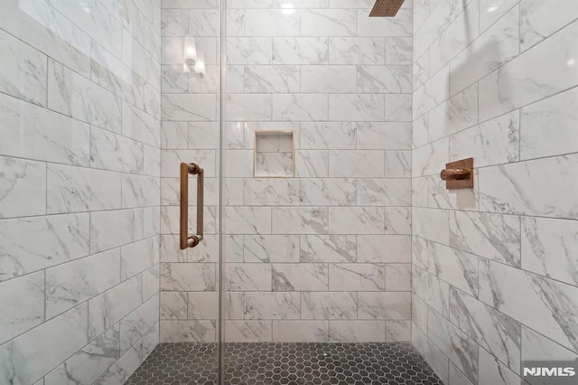 bathroom with tiled shower