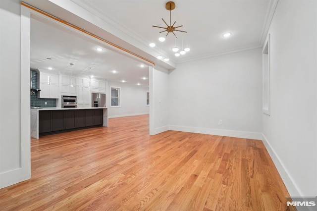 unfurnished living room with ceiling fan, light hardwood / wood-style floors, and crown molding