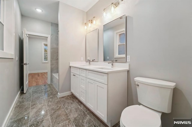 bathroom featuring toilet and vanity