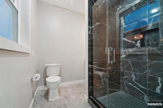 bathroom featuring toilet and an enclosed shower