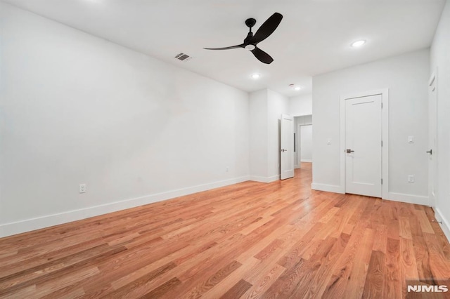 empty room with light wood-type flooring and ceiling fan