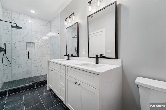 bathroom featuring toilet, an enclosed shower, and vanity