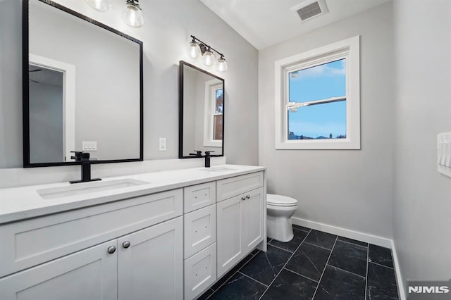 bathroom featuring vanity and toilet