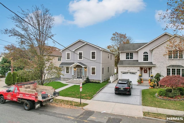 view of property with a front yard and a garage