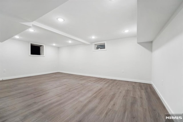 basement with hardwood / wood-style flooring