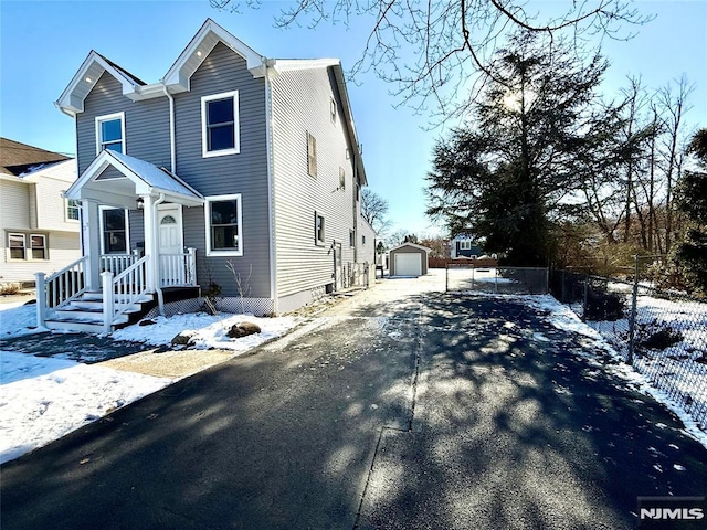 view of front of property featuring an outbuilding and a garage