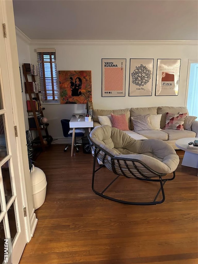 living room featuring crown molding, dark hardwood / wood-style flooring, and plenty of natural light