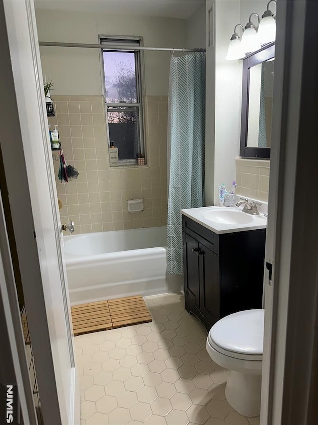 full bathroom featuring toilet, backsplash, tile patterned floors, shower / bathtub combination with curtain, and vanity