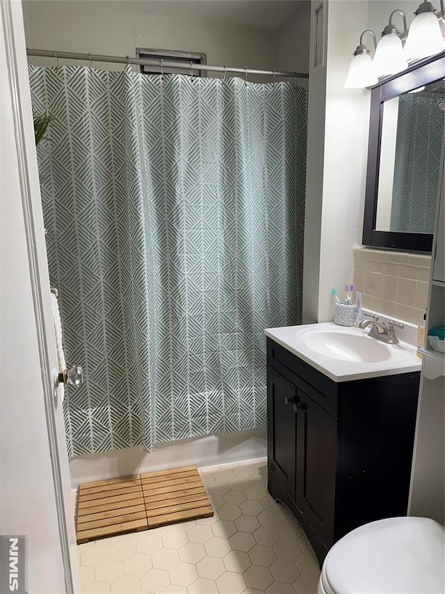 bathroom with tile patterned floors, backsplash, vanity, and a shower with curtain