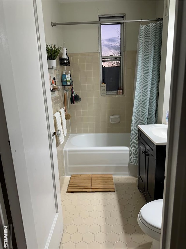 full bathroom with toilet, shower / tub combo, vanity, and tile patterned floors