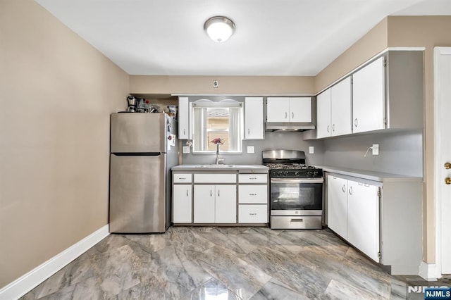 kitchen with stainless steel appliances, white cabinetry, and sink