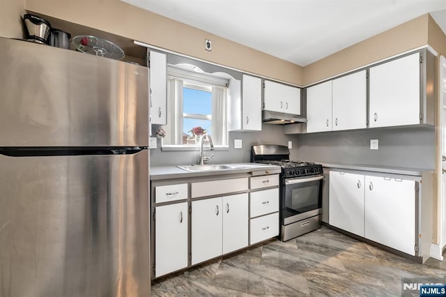 kitchen featuring stainless steel appliances, sink, and white cabinets