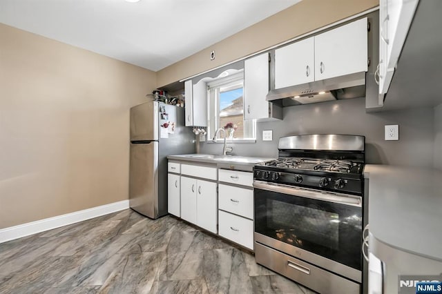 kitchen featuring appliances with stainless steel finishes, sink, and white cabinets