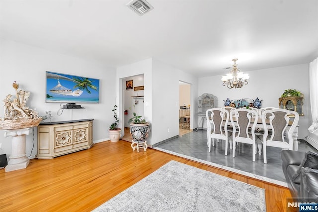 dining room featuring an inviting chandelier and hardwood / wood-style floors