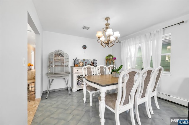 dining area with a baseboard heating unit and a chandelier