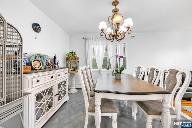 dining area featuring a notable chandelier