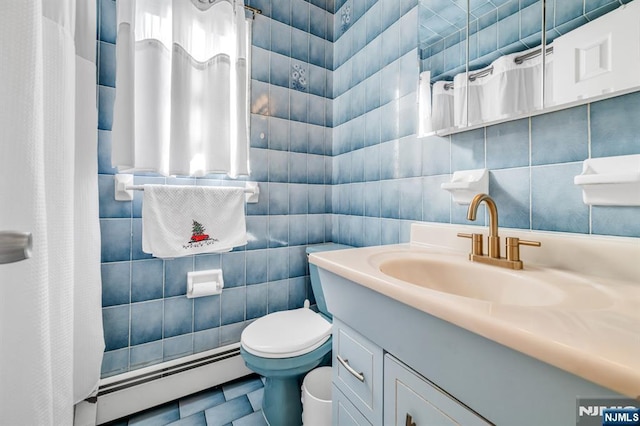 bathroom featuring a baseboard radiator, vanity, toilet, and tile walls