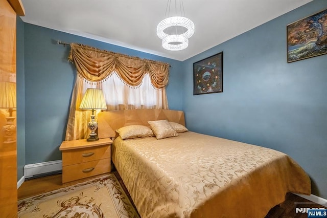 bedroom featuring a notable chandelier, a baseboard radiator, and light hardwood / wood-style floors