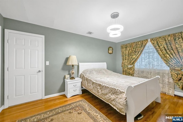 bedroom with wood-type flooring