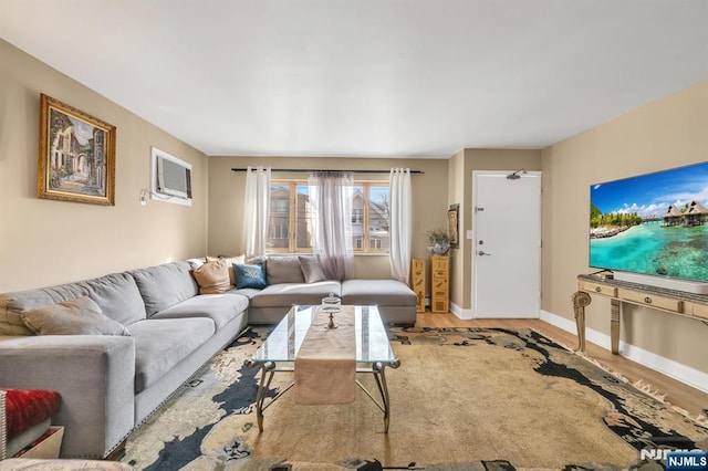 living room with wood-type flooring and a wall unit AC