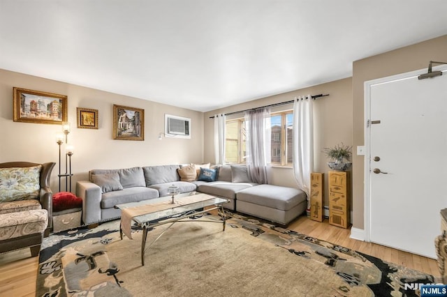 living room featuring a wall mounted air conditioner and light wood-type flooring