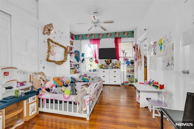 bedroom with ceiling fan and dark hardwood / wood-style floors