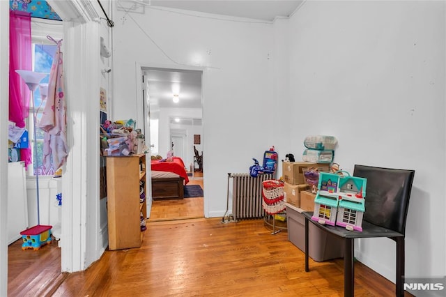 interior space featuring hardwood / wood-style floors and radiator heating unit